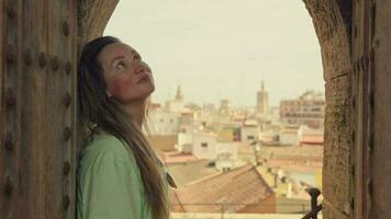 The girl enjoys the view of Valencia from an ancient castle. video