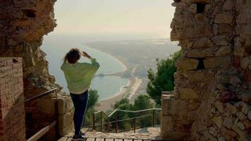 The girl in the ancient castle looks at the city video