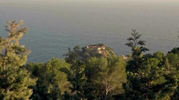 House on a green hill against the backdrop of the sea video