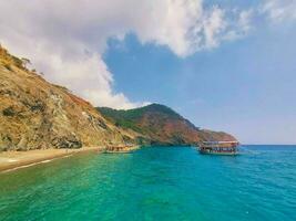 View from the sea to the mountains and the blue sky with clouds photo