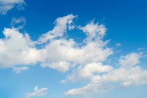 The blue summer sky with white fluffy clouds. Photo from window on the airplane.