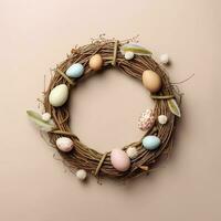 Wreath with eggs. Wreath made of willow twigs and Easter eggs on a pastel background. photo