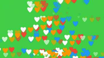 Raining red hearts confetti - green background in 4k. A colorful heart with an effect resembling raining video