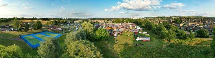 High Angle Footage of Public Funfair Held at Lewsey Public Park of Luton with Free Access for Muslim Community on Islamic Holy Eid Festival Day. Footage Captured with Drone's Camera on June 29th, 2023 photo