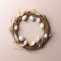 Wreath with eggs. Wreath made of willow twigs and Easter eggs on a pastel background. photo