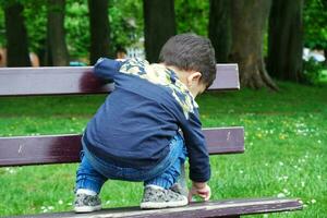 Cute Asian Pakistani Baby is Enjoying The Beautiful Sunny Day at Wardown Children and Public Park of Luton Town of England UK. Low Angle  Image Was Captured on April 03rd, 2023 photo