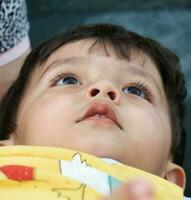 Cute Asian Pakistani Baby Boy is Playing in the Home Garden at Luton City of England UK. Image Was Captured on April 3rd, 2023 photo