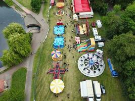 High Angle Footage of Public Funfair Held at Wardown Public Park of Luton with Free Access for Muslim Community on Islamic Holy Eid Festival Day. Captured with Drone's Camera on July 2nd, 2023 photo