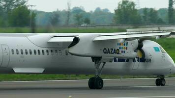 ALMATY, KAZAKHSTAN MAY 4, 2019 - Bombardier DASH 8 Qazaq Airlines P4 AST braking after landing, Almaty International Airport, Kazakhstan video