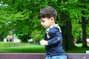 Cute Asian Pakistani Baby is Enjoying The Beautiful Sunny Day at Wardown Children and Public Park of Luton Town of England UK. Low Angle  Image Was Captured on April 03rd, 2023 photo