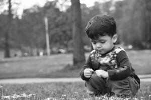 Cute Asian Pakistani Baby is Enjoying The Beautiful Sunny Day at Wardown Children and Public Park of Luton Town of England UK. Low Angle  Image Was Captured on April 03rd, 2023 photo