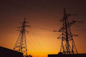 High-voltage power lines at sunset. Electricity distribution station.  electricity pylons on the background of the sky photo