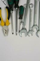 Set of tools for repair in a case on a white background. Assorted work or construction tools. Wrenches, Pliers, screwdriver. Top view photo