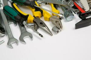 Set of tools for repair in a case on a white background. Assorted work or construction tools. Wrenches, Pliers, screwdriver. Top view photo