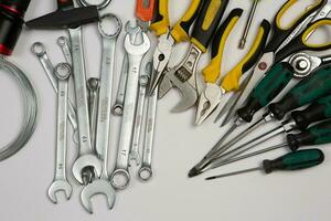 Set of tools for repair in a case on a white background. Assorted work or construction tools. Wrenches, Pliers, screwdriver. Top view photo