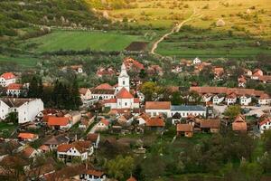 Rimetea is a small village located in Transylvania, Romania. It is situated in the Apuseni Mountains and is known for its picturesque setting and well preserved Hungarian architectural style. photo