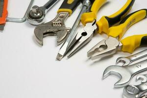 Set of tools for repair in a case on a white background. Assorted work or construction tools. Wrenches, Pliers, screwdriver. Top view photo