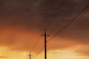 High-voltage power lines at sunset. Electricity distribution station.  electricity pylons on the background of the sky photo