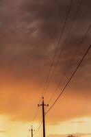 High-voltage power lines at sunset. Electricity distribution station.  electricity pylons on the background of the sky photo