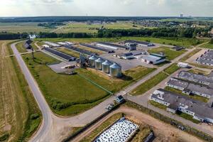 aerial panoramic view on agro-industrial complex with silos and grain drying line for drying cleaning and storage of cereal crops photo