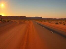 A road in the desert with the sun setting photo