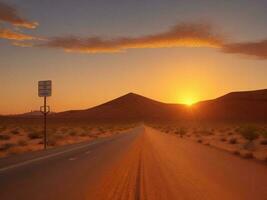 A road in the desert with the sun setting photo