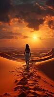 illustration of a landscape of mountains far away and desert of sand dunes, sunset piercing cloudy sky. Woman walking alone photo