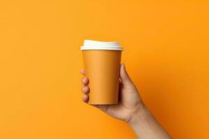 Generative AI illustration of paper coffee cup in a hand, isolated orange background photo
