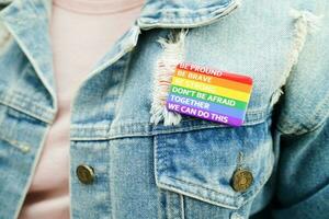 Asian woman with rainbow flag, LGBT symbol rights and gender equality, LGBT Pride Month in June. photo