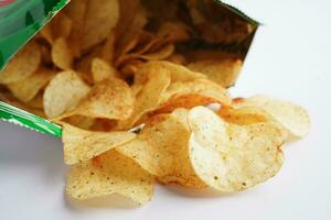 Potato chips in open bag, delicious BBQ seasoning spicy for crips, thin slice deep fried snack fast food in open bag. photo