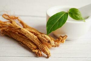 Ginseng roots and green leaf, healthy food. photo