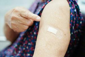 Asian elder senior woman getting vaccine for protect corona virus. photo