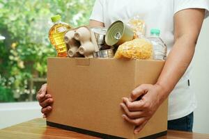 Foodstuffs in donation box for volunteer to help people. photo