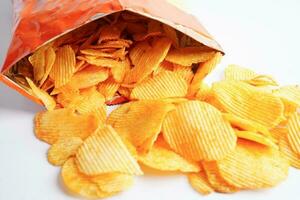 Potato chips in open bag, delicious BBQ seasoning spicy for crips, thin slice deep fried snack fast food. photo