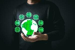 man hold the global to save energy,and reduce global warming,climate change,ecology friendly investment,ESG environment social governance,Green Business Innovation and Sustainable Development concept. photo