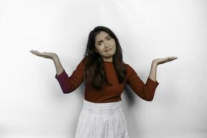 A thoughtful young Asian woman is wearing red t-shirt looks confused between choices, isolated by white background photo