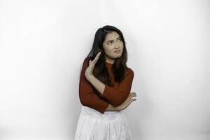 Attractive Asian woman wearing red t-shirt with hand gesture pose rejection or prohibition isolated by white background photo