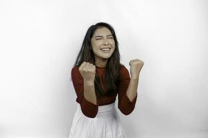 A young Asian woman with a happy successful expression wearing red top isolated by white background photo