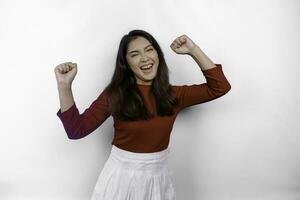 A young Asian woman with a happy successful expression wearing red top isolated by white background photo