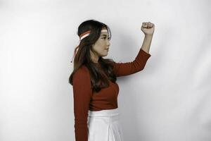 Indonesian woman celebrate Indonesian independence day on 17 August by wearing the Indonesian flag ribbon isolated over white background photo