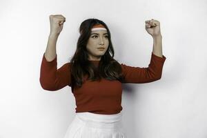 Indonesian woman celebrate Indonesian independence day on 17 August by wearing the Indonesian flag ribbon isolated over white background photo