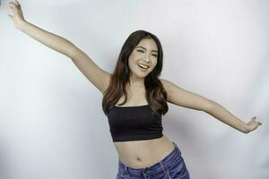 Portrait of happy young Asian woman wearing crop top isolated over white background. Diet concept. photo