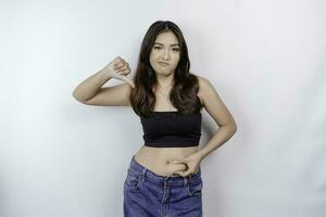 A sad young Asian woman pinching flabby skin fat belly isolated by white background photo