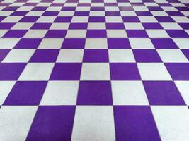 Purple and white tiled floor symmetrical with a grid texture in perspective perspective for a permanent tiled floor background. red white square Made of ceramic material for flooring photo