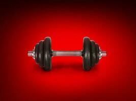 Steel dumbbells, isolated on red background photo