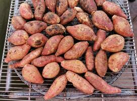 Roasted sweet potatoes on a hot stove photo