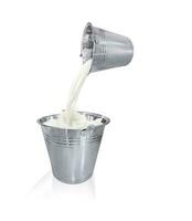 Pour the milk out of the metal can. Milk splashes. photo