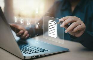 Businesswoman working on laptop with virtual screen. Online documentation database, IT consultant being set up Virtual Document Management System with a laptop, Software for archiving corporate files. photo