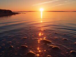 Sunset over calm ocean waters with warm hues and mesmerizing reflections - photo