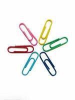 multi-colored star shaped paper clips on a white background photo
